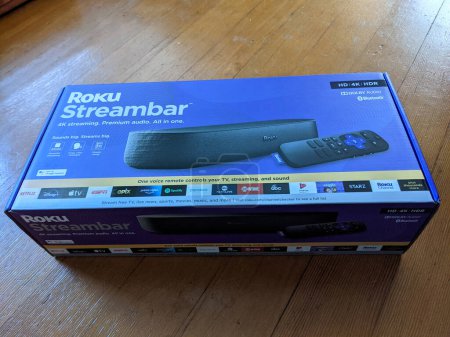 Photo for Honolulu - June 6, 2021:  Dive into the world of immersive entertainment with the Roku Streambar, the ultimate all-in-one streaming device that combines 4K streaming and premium audio in a sleek package. In this captivating image, we present the Roku - Royalty Free Image