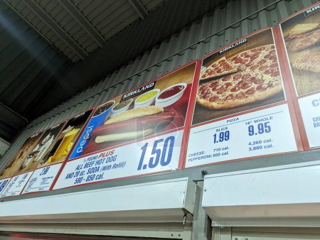 Photo for Honolulu - December 29, 2022:  Menu board at a Costco food court, with prices and pictures of the available items. The photo shows the hot dog plus, pizza, and drinks sections of the menu, with calorie counts and product information. - Royalty Free Image