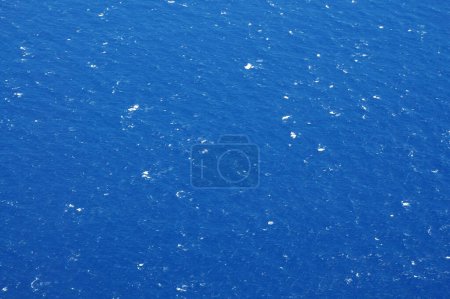 A deep blue Pacific ocean sea with white foam patterns from waves off Hawaii.