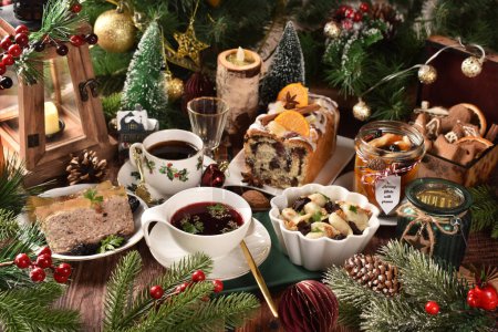 Photo for Christmas Eve's supper with traditional Polish dishes and pastries on festive table in rustic style - Royalty Free Image