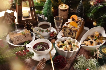 Christmas Eve's supper with traditional Polish dishes and pastries on festive table in rustic style