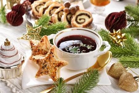 Red borscht and star shaped puff pastry pies filled with mushrooms for Christmas Eve's supper in Poland 