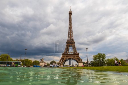 Photo for Paris, France - August 29 2023: Tourists and Eiffel tower seen from Trocadero Fountains in a cloudy day. Photography taken in Paris. - Royalty Free Image