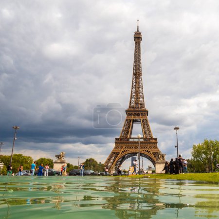Photo for Paris, France - August 29 2023: Tourists and Eiffel tower seen from Trocadero Fountains in a cloudy day. Squared photography taken in Paris. - Royalty Free Image