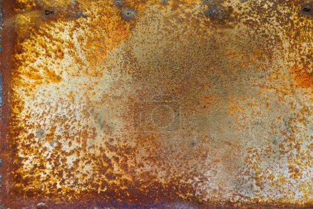 Photo for Close up of a brownish rusted sheet metal surface with yellowish and orange hue and amber patina. - Royalty Free Image
