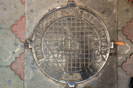 Photo for Soviet sewers manhole cover in public market, letters means technical specifications Kyrgyz SSR Ivanovo Mechanical Repair Plant - Dordoi bazar, Bishkek, Kyrgyzstan - March 3, 2023 - Royalty Free Image