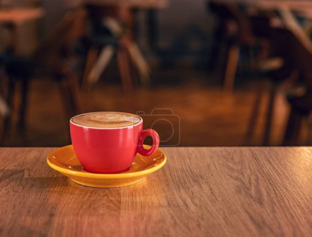 Photo for Hot art latte coffee in a cup on wooden table and coffee shop - Royalty Free Image