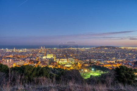 The skyline of Barcelona in Spain at dusk