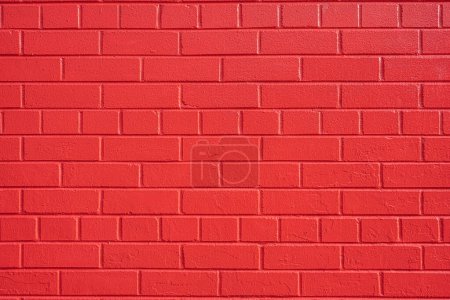 Fondo de una pared hecha de ladrillos pintados de rojo