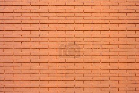 Fondo de una pared hecha de ladrillos pintados de naranja