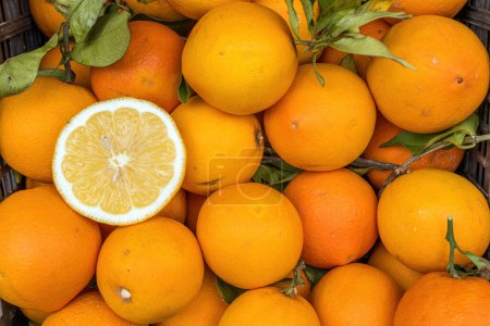 A pile of oranges for sale at a market
