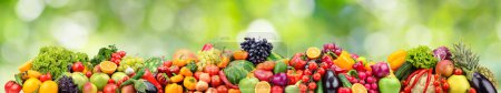 Photo for Bright berries, fruits and vegetables on green blurred background. - Royalty Free Image