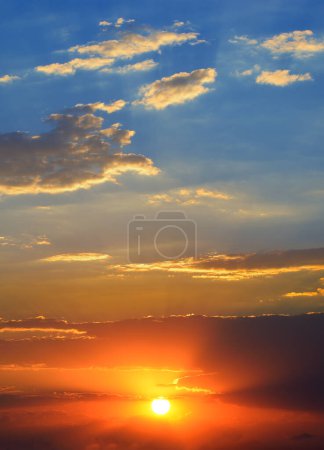 Photo for Dramatic sunset background with bright sun, blue sky and picturesque clouds. - Royalty Free Image