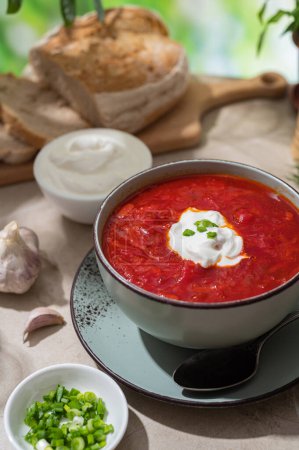 Photo for Ukrainian red borscht. Traditional Ukrainian soup. Lunch outdoors in the summer. Healthy food, family traditions. - Royalty Free Image