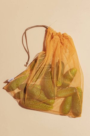 Photo for Cucumbers stored in an eco-friendly tote bag, promoting conscious and sustainable usage. This image represents the importance of eco-conscious choices and encourages responsible consumer behavior - Royalty Free Image