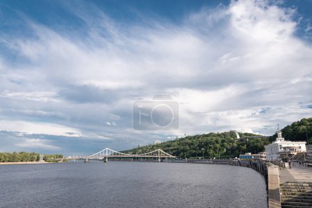 Photo for View from the embankment to the slopes of the Dnipro in Kyiv and the Pedestrian (park) bridge - Royalty Free Image
