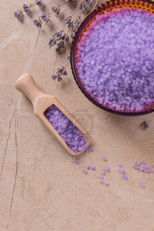 Photo for Lavender cooking salt in glass decorative plate with wooden spoon on marble tabletop - Royalty Free Image
