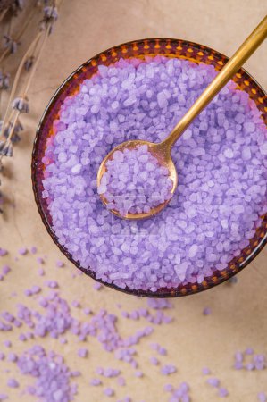 Photo for Lavender cooking salt in glass decorative plate with gold teaspoon on marble tabletop - Royalty Free Image