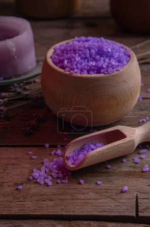 Photo for Lavender salt and scented candle for the bathroom, for spa and relaxation in a rural cottage interior. Wooden warm texture, coziness. Aromatherapy, relaxation - Royalty Free Image