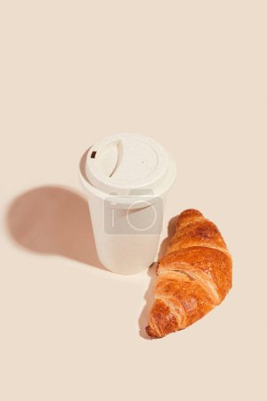 Photo for Fresh delicious croissants with an eco cup on a light background. Environmental friendliness, secondary use - Royalty Free Image