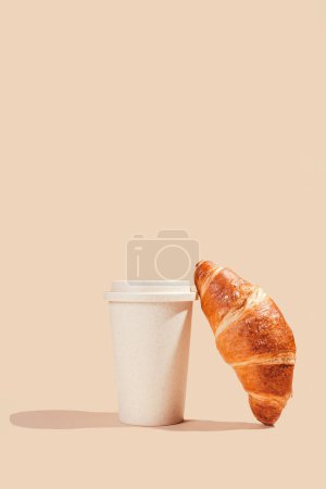 Photo for Fresh delicious croissants with an eco cup on a light background. Environmental friendliness, secondary use - Royalty Free Image