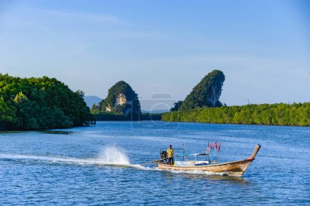 Photo for KRABI, THAILAND - July 26, 2012 : Thai's fisherman riding a small boat to trap some fish - Royalty Free Image