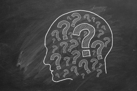 Photo for Human head with question marks inside. lustration on blackboard. - Royalty Free Image