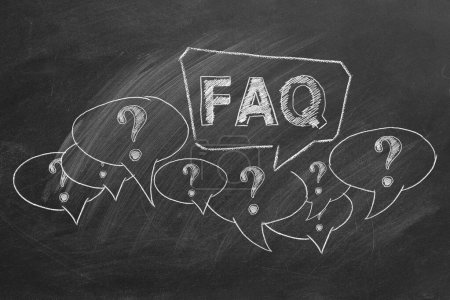 Foto de Hand drawn text FAQ, question marks with speech bubbles on blackboard. Frequently Asked Questions. - Imagen libre de derechos