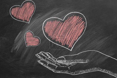 Photo for Hearts in a female hand. Chalk drawn illustration. Heart transplant and organ donation. The concept of charity, love, donate and helping hand. I Love You. Happy Valentines day. World heart day - Royalty Free Image