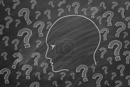 Photo for Human head with question marks. Illustration on blackboard. - Royalty Free Image