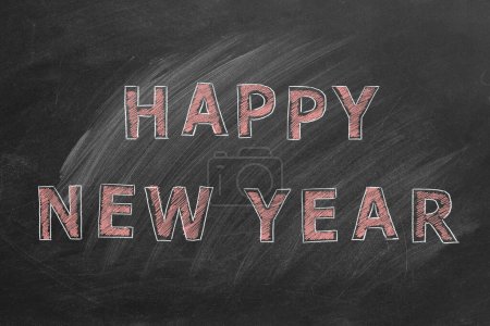 Téléchargez les photos : Hand drawn text HAPPY NEW YEAR on blackboard. - en image libre de droit