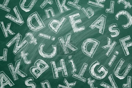 Photo for Uppercase and lowercase Latin letters are written in chalk on a school blackboard. - Royalty Free Image