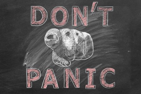 Closeup of a human hand pointing at you with lettering DONT PANIC. Illustration drawn in chalk on a blackboard.