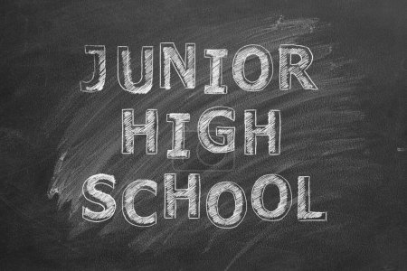 Photo for Lettering  Junior high school on black chalkboard. - Royalty Free Image