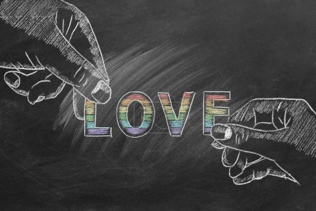 Two hands drawn in chalk hold the word LOVE, filled with the vibrant colors of the LGBT pride flag