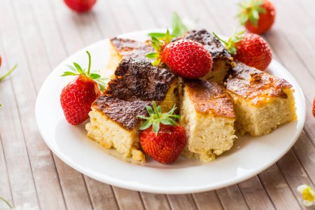 prepared cottage cheese casserole with fresh strawberries .