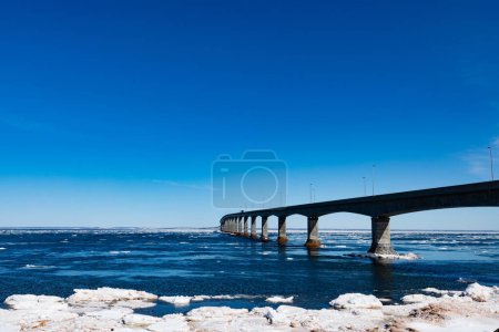 Photo for Concrete structure of Confederation Bridge spans Atlantic Ocean between New Brunswick and Prince Edward Island, Canada, some ice floes drifting - Royalty Free Image