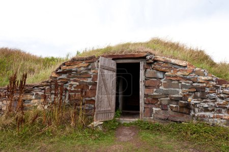 Open door historic vintage root cellar dug underground near Elliston, Newfoundland, NL, Canada
