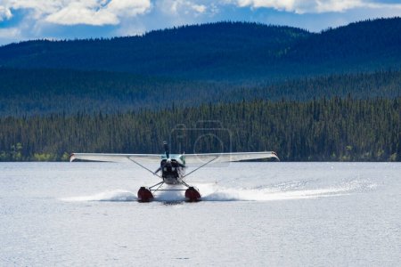 Photo for Float plane landing on remote wilderness lake in boreal forest taiga of Yukon Territory, Canada - Royalty Free Image