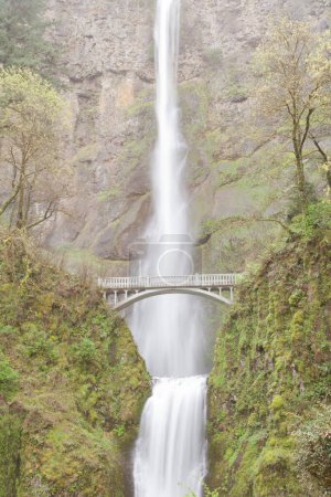 Multnomah Falls with silky water and Benson Footbridge, famous landmark in Columbia River valley near Portland, Oregon, OR, USA