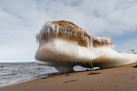 Photo for Bizarre chunk of ice floe beached on sand of Melmerby Beach Provincial Park near Merigomish, Nova Scotia, NS, Canada - Royalty Free Image