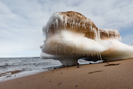 Photo for Bizarre chunk of ice floe beached on sand of Melmerby Beach Provincial Park near Merigomish, Nova Scotia, NS, Canada - Royalty Free Image