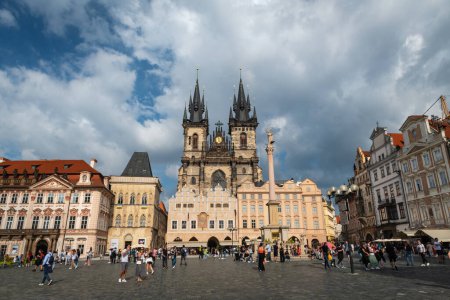 PRAGUE, CZECH REPUBLIC - AUGUST 24, 2022: Wide-angle view of a crowded Old Town Square in Prague, with the Church of Our Lady before Tyn against a cloudy sky.