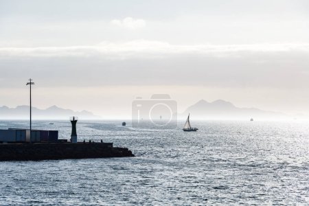Photo for Boats sailing in the Ria de Vigo in Galicia at sunset, with the Cies Islands in the background. - Royalty Free Image