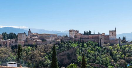 GRANADA, SPAIN: MARCH 25, 2023: Panorama view of the Alhambra in Granada on a clear Spring day, a palace and fortress complex that remains one of the most famous monuments of Islamic architecture.
