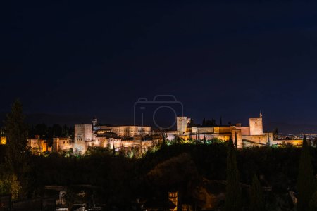 GRANADA, SPAIN: MARCH 24, 2023: Panorama view of the Alhambra in Granada on a clear Spring night, a palace and fortress complex that remains one of the most famous monuments of Islamic architecture.