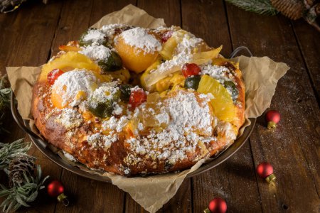 Photo for Bolo do Rei or King's Cake, Made for Christmas, Carnavale or Mardi Gras with Christmas season elements in Background. - Royalty Free Image