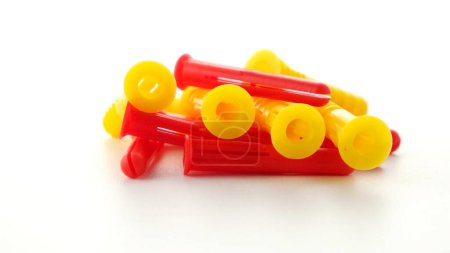 Photo for Closeup of colorful plastic dowels isolated on white background. - Royalty Free Image