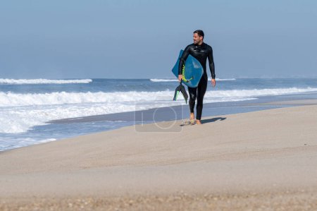 Photo for Bodyboarder walking in in S. Torrao do Lameiro in Ovar - Portugal. - Royalty Free Image