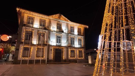 Photo for Oliveira de Azemeis, Portugal - november 30 2023: A walker's point of view of the city streets decorated with Christmas lights. The decoration remains the same throughout the Perlim theme park. - Royalty Free Image